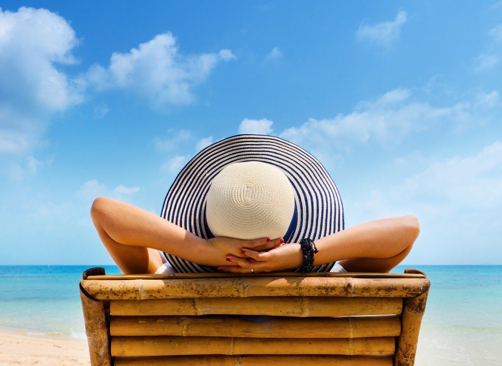 woman lying beside the beach