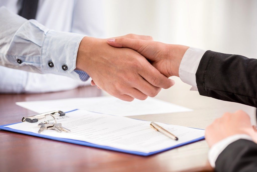 Handshake of a real estate agent and a client