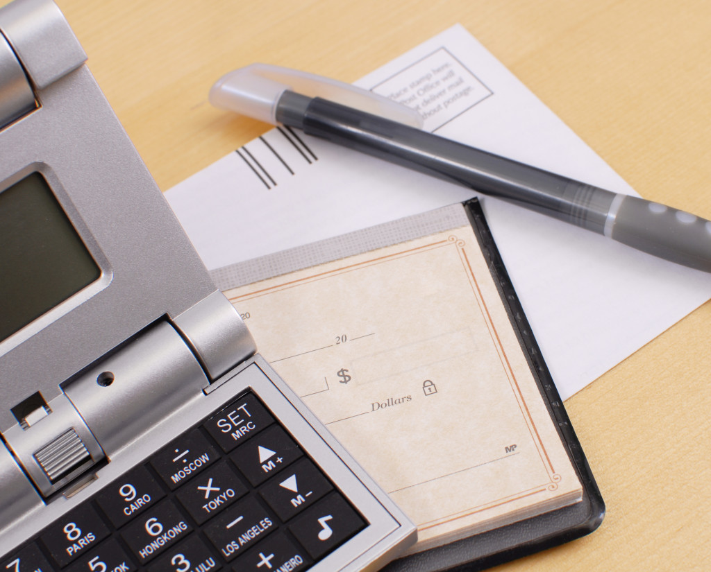 calculator pen and checkbook